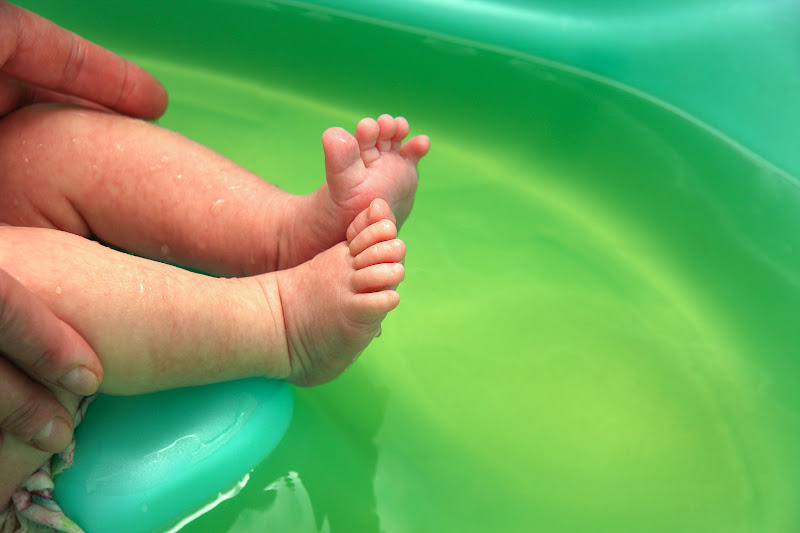 Baby is given bath in warm water