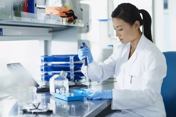 A lab tech is testing in a lab.
