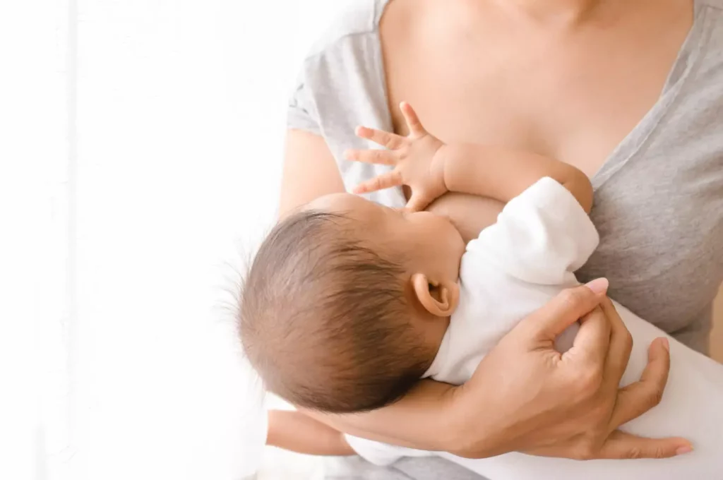 A mother is breastfeeding her baby 